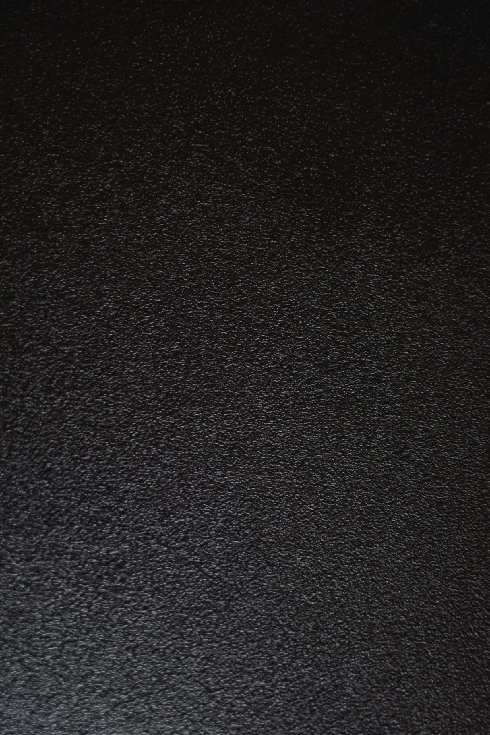 A detailed and textured black surface ideal for backgrounds and design projects.