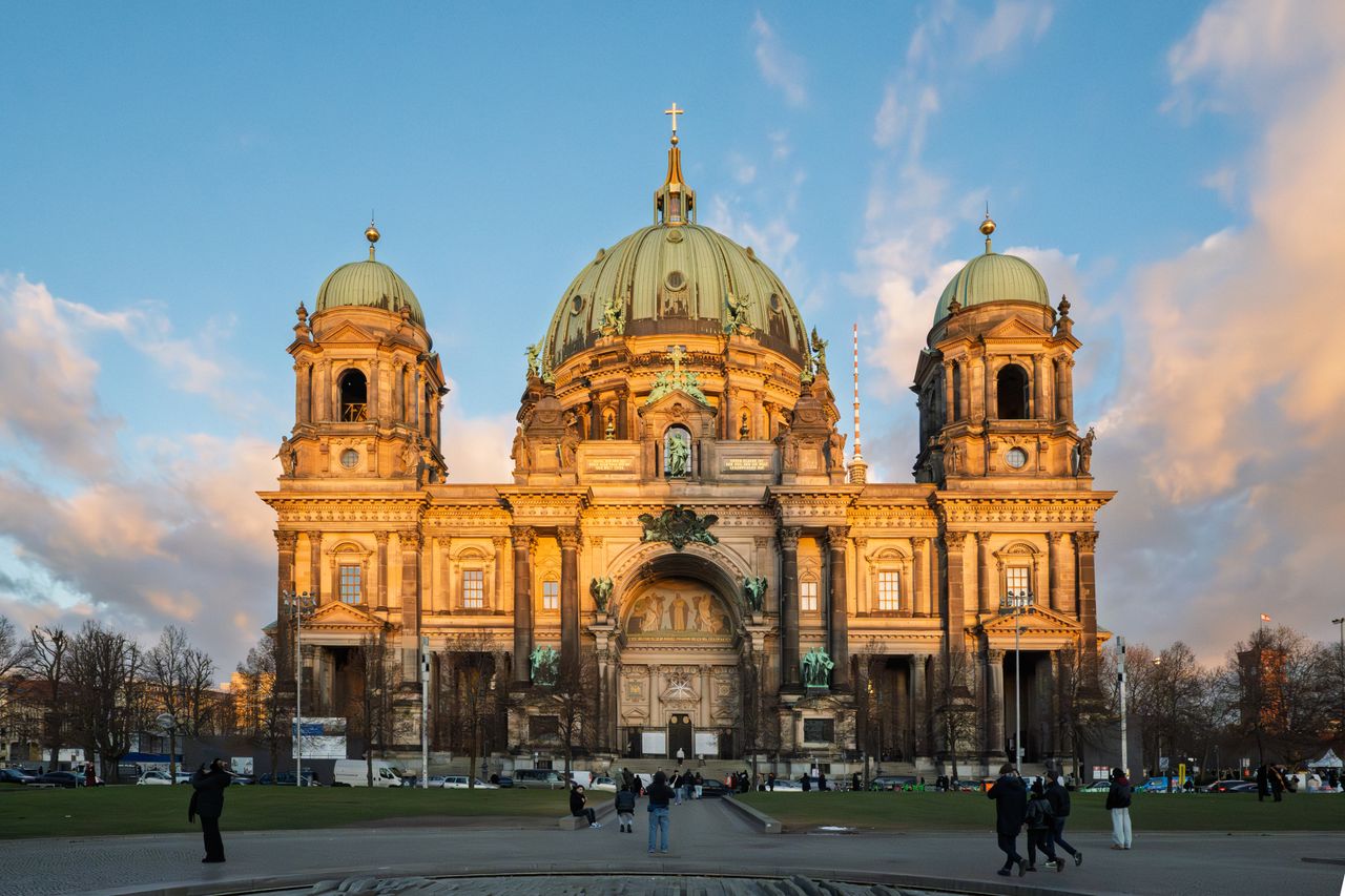Stunning view of the Berlin Cathedral illuminated by sunset, highlighting architectural beauty.
